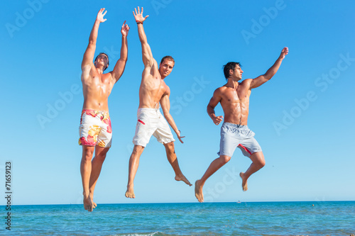 Three young men on the beach