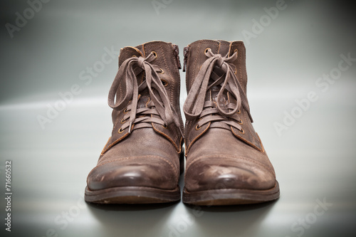 Expensive shoes autumn brown on gray abstract background