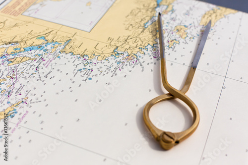 Pair of compasses for navigation on a sea map