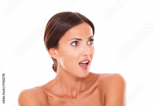 Surprised beautiful woman looking to her left