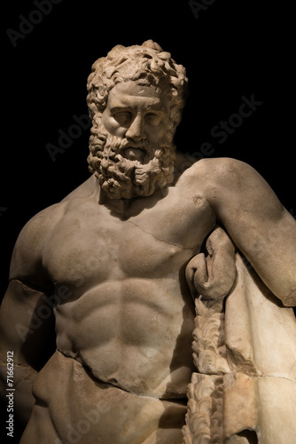 A statue of powerful Hercules, closeup, isolated in black