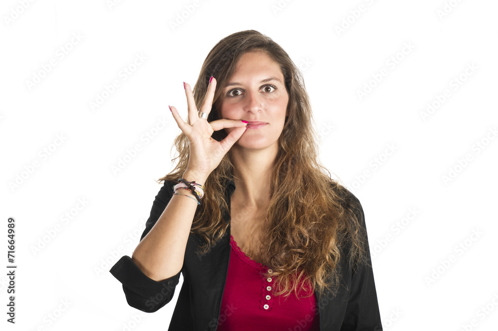 Young girl making silence gesture over white background