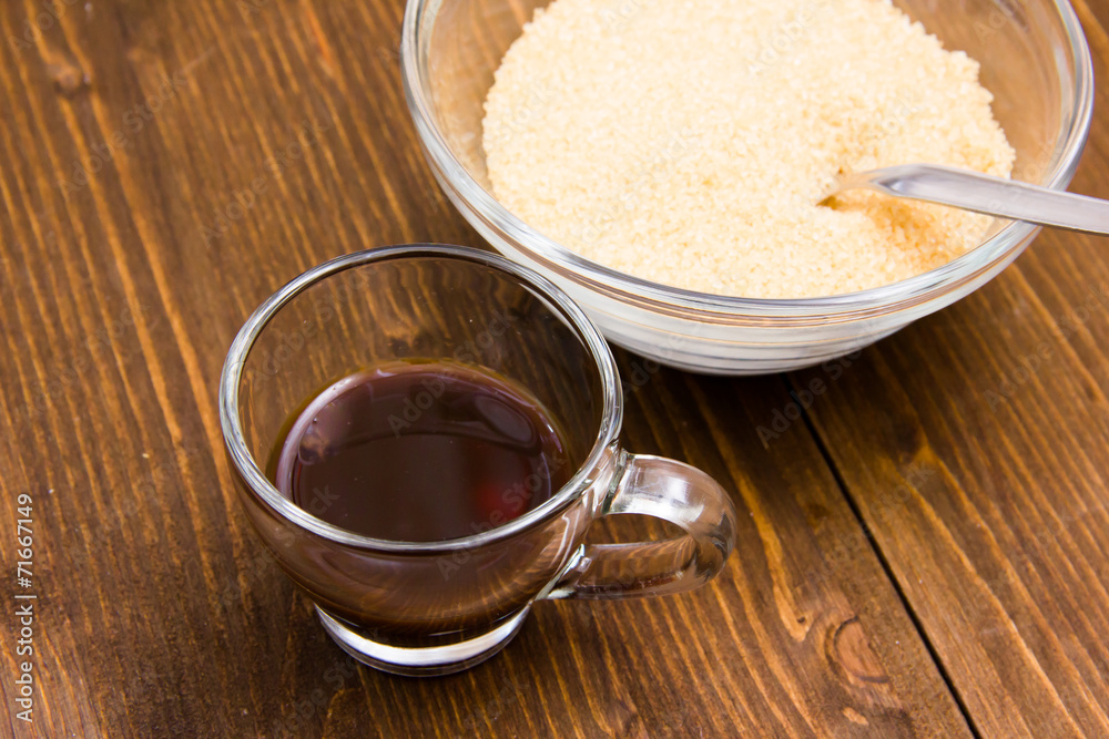 Coffee and bowl with brown sugar on wooden table from above Coffee and bowl with brown sugar on wooden table from above
