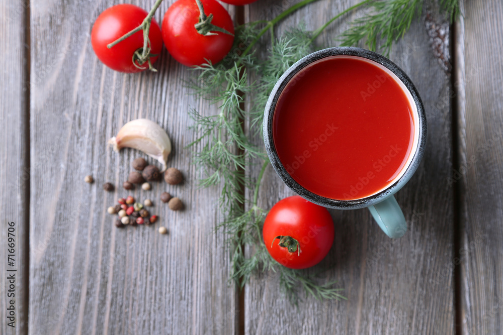 Homemade tomato juice in color mug, spices and fresh tomatoes Homemade tomato juice in color mug, spices and fresh tomatoes