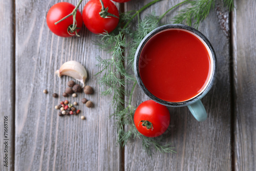 Homemade tomato juice in color mug, spices and fresh tomatoes
