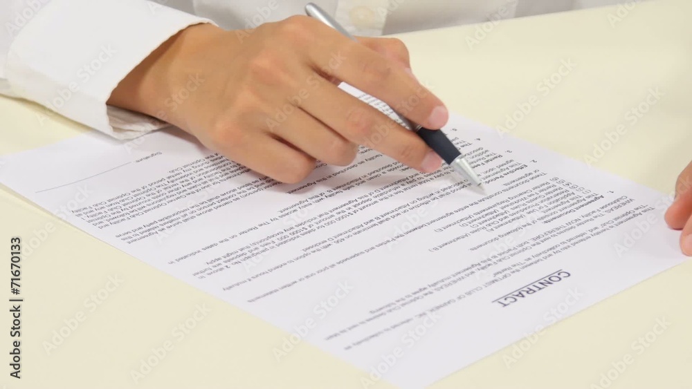 Business worker signing the contract to conclude a deal Business worker signing the contract to conclude a deal
