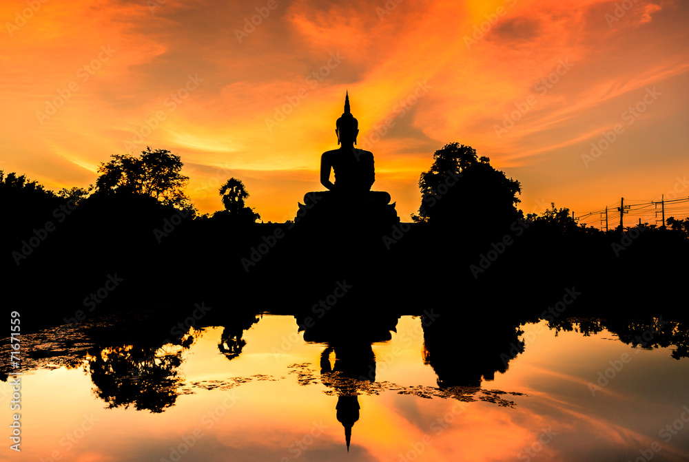 silhouette big buddha statue sitting reflection on the water
