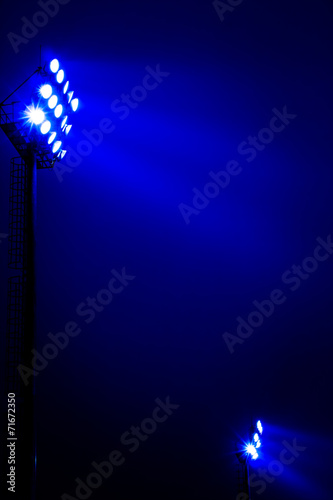 Stadium floodlights on a sports field at night