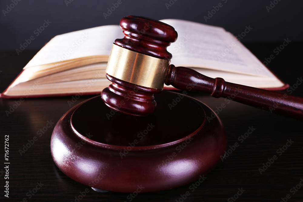 Judge's gavel and open book on table Judge's gavel and open book on table