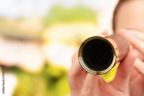 Photos Modern spyglass in hands on bright background