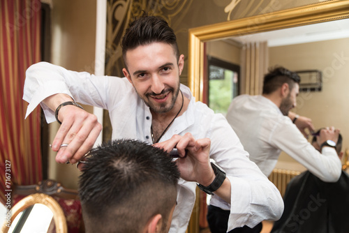 Hairdresser Trimming Black Hair With Scissors