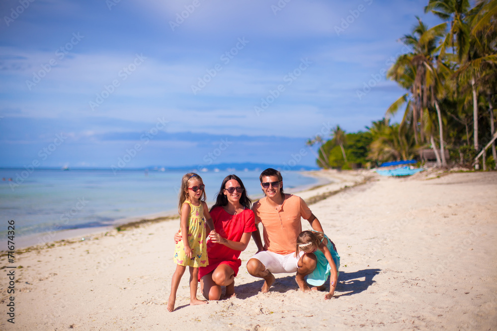 Family of four on beach vacation