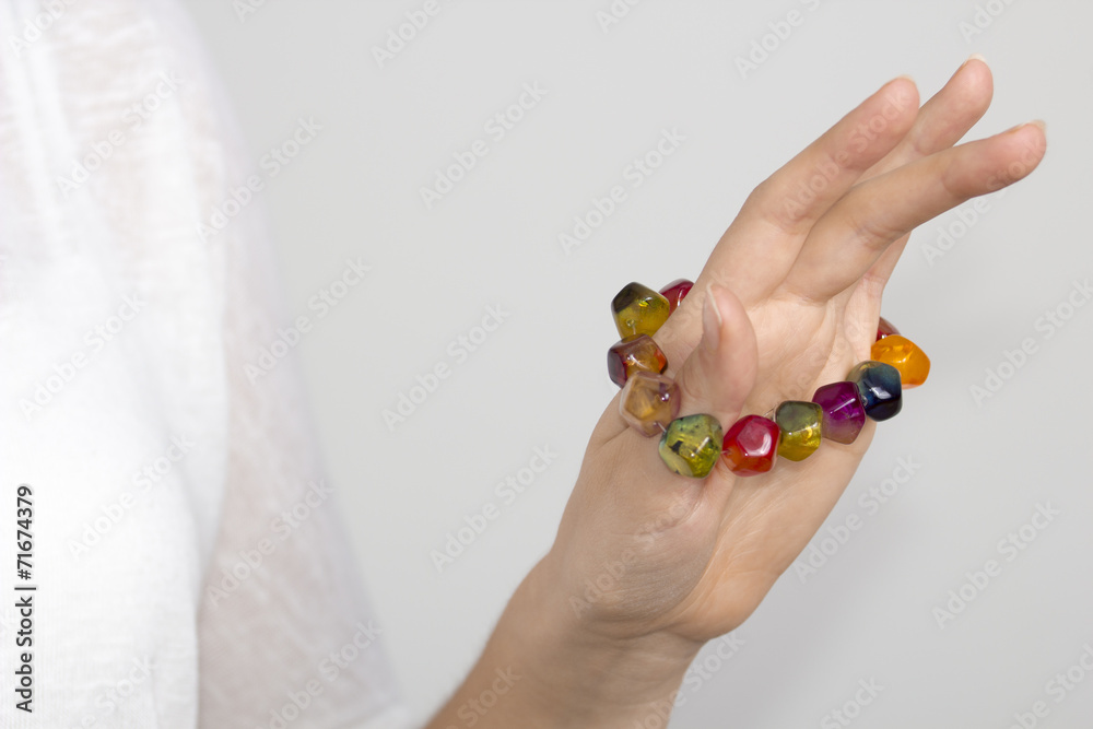Young woman's hand with multi color bracelet Young woman's hand with multi color bracelet