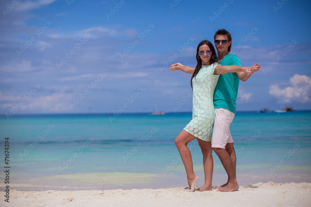 Young couple enjoying each other on sandy white beach Young couple enjoying each other on sandy white beach
