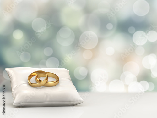 A pair of gold wedding rings with bokeh background