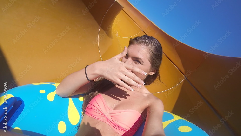 Girl rides on the slide at the water park