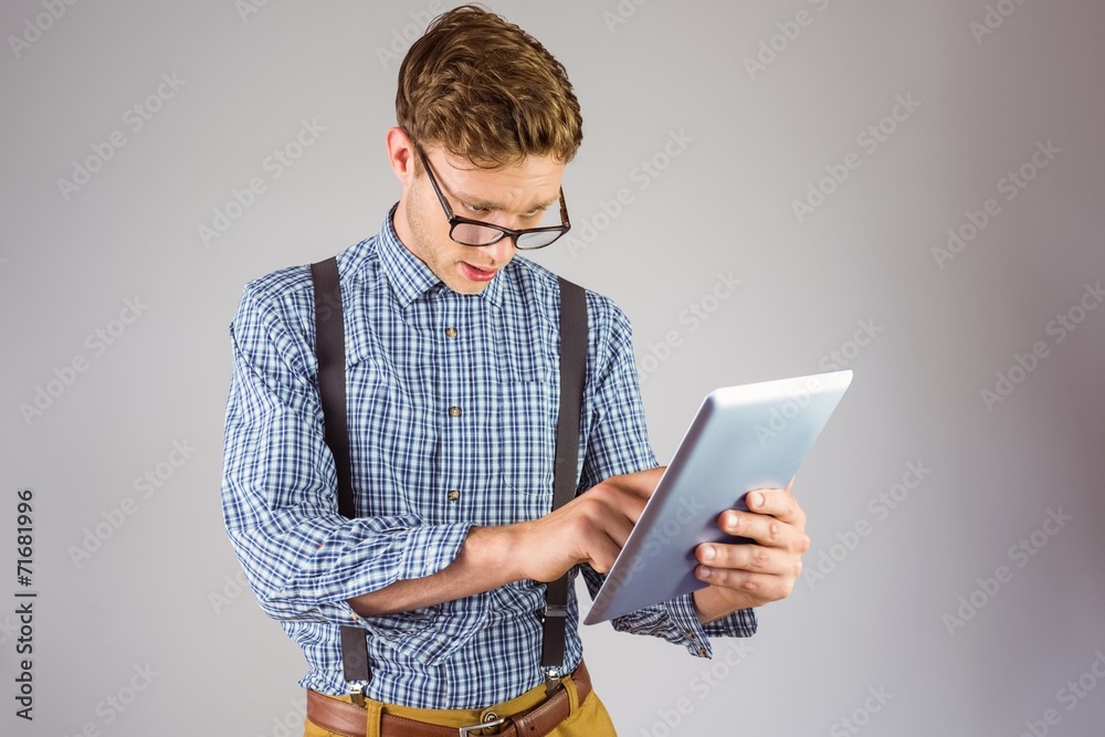 Geeky businessman using his tablet pc Geeky businessman using his tablet pc
