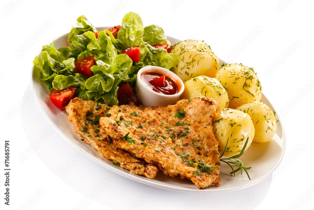 Fried pork chop, boiled potatoes and vegetable salad Fried pork chop, boiled potatoes and vegetable salad