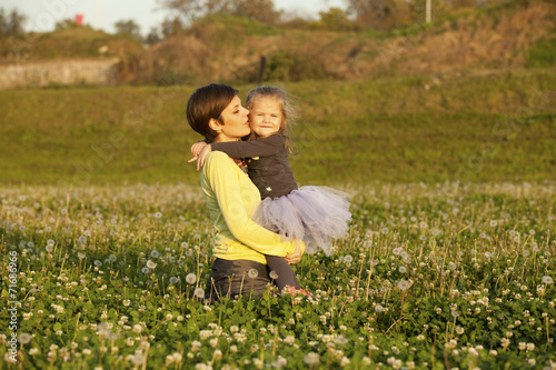 Happy Family Mother And Daughter On Daisy and Dandelion Field