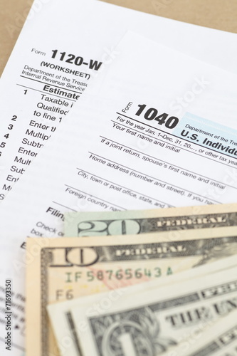 U.S. income tax form and dollar bill