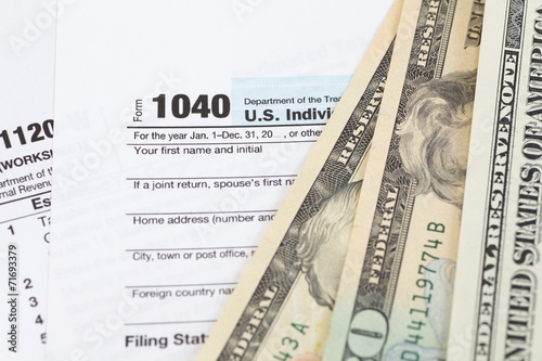 U.S. income tax form and dollar bill