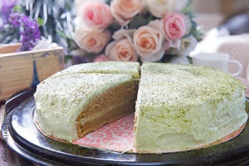 close up big pound of green tea cake sliced on table top photo