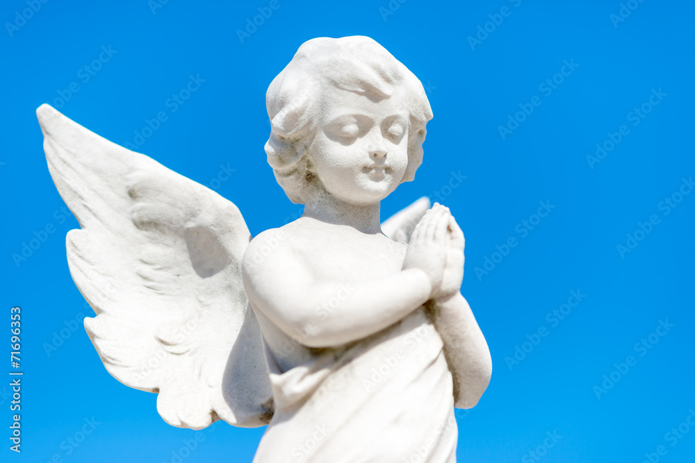 Beautiful infant angel on a blue sky