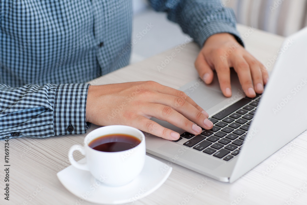 man typing on a laptop keyboard in the office man typing on a laptop keyboard in the office