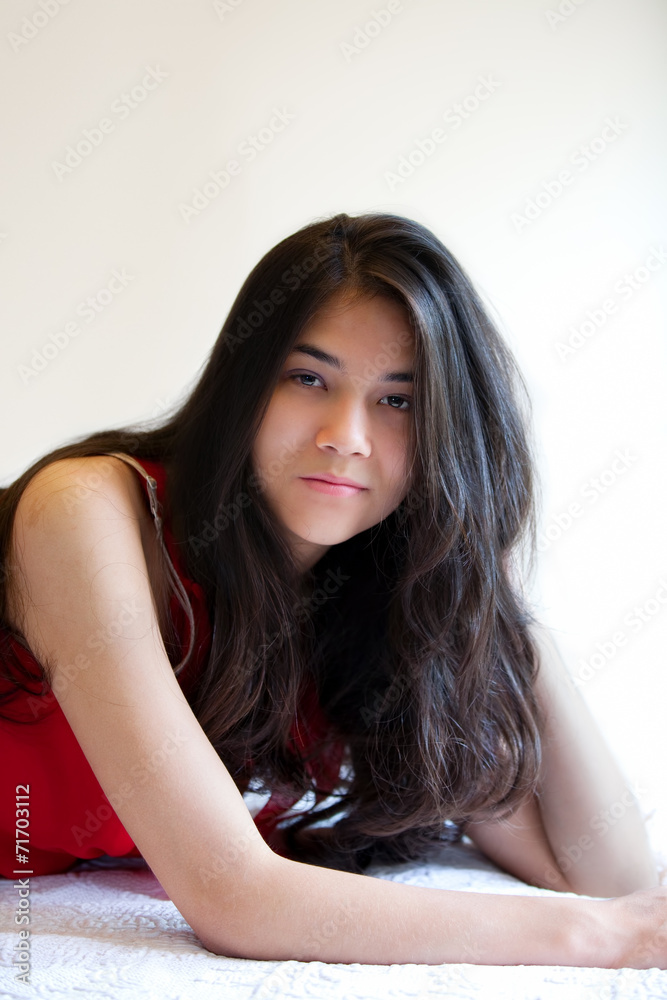 Beautiful biracial teen girl lying down, relaxing Beautiful biracial teen girl lying down, relaxing
