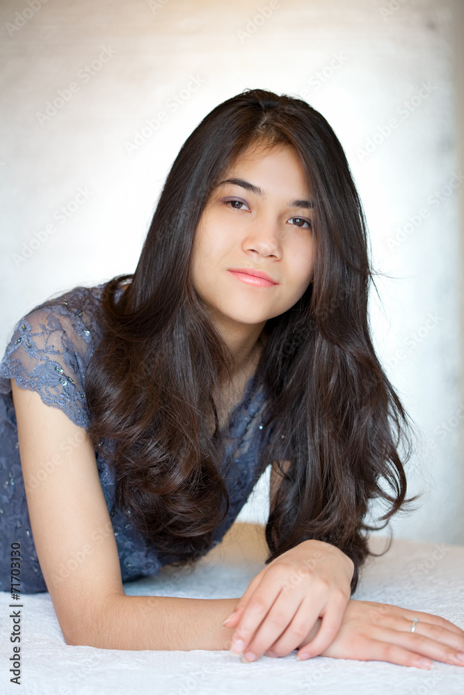 Beautiful biracial teen girl lying down, relaxing Beautiful biracial teen girl lying down, relaxing