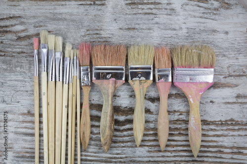 Set of paintbrushes in a wood background photo