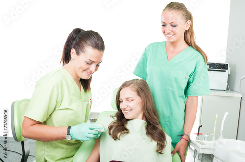 Woman dentist, assistant and patient.