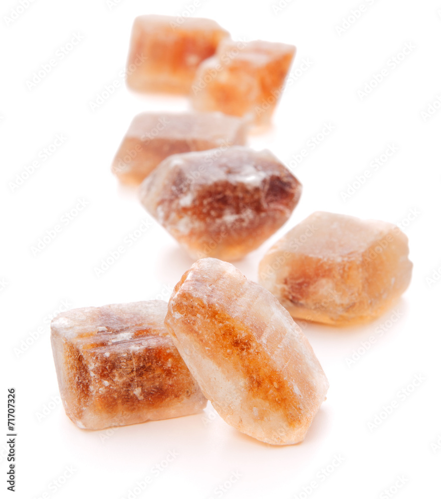 Brown caramelized lump cane sugar cube isolated on white backgro