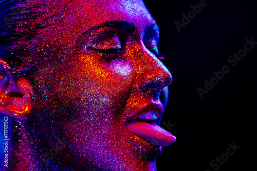 Glitter makeup on a beautiful woman face on a black background