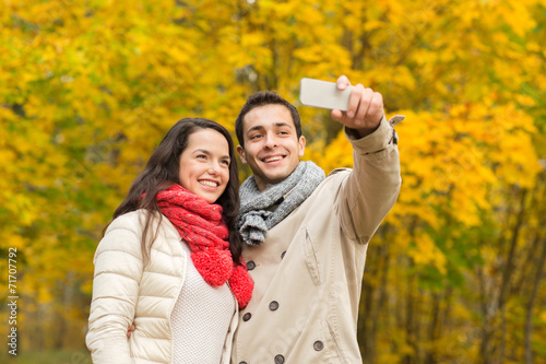 smiling couple hugging in autumn park