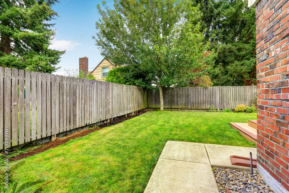 Backyard with wooden fence and walkway Backyard with wooden fence and walkway
