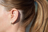 hearing aid in the ear close up. Modern-ear hearing instruments
