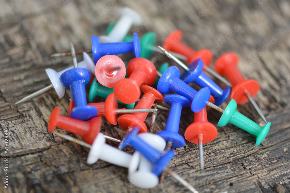 old push pins set on old wooden background