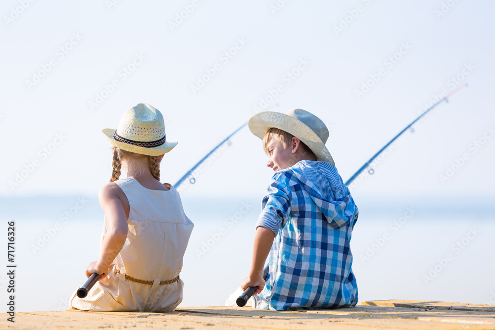 Boy and girl with fishing rods Boy and girl with fishing rods
