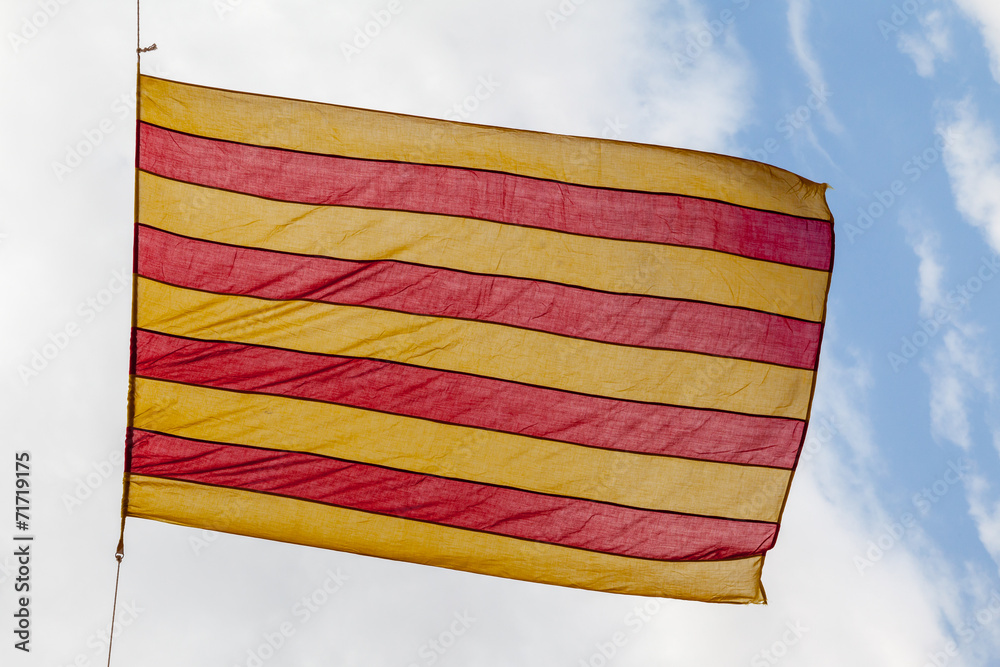 Flag Catalonia above blue cloudy sky - obrazy, fototapety, plakaty 
