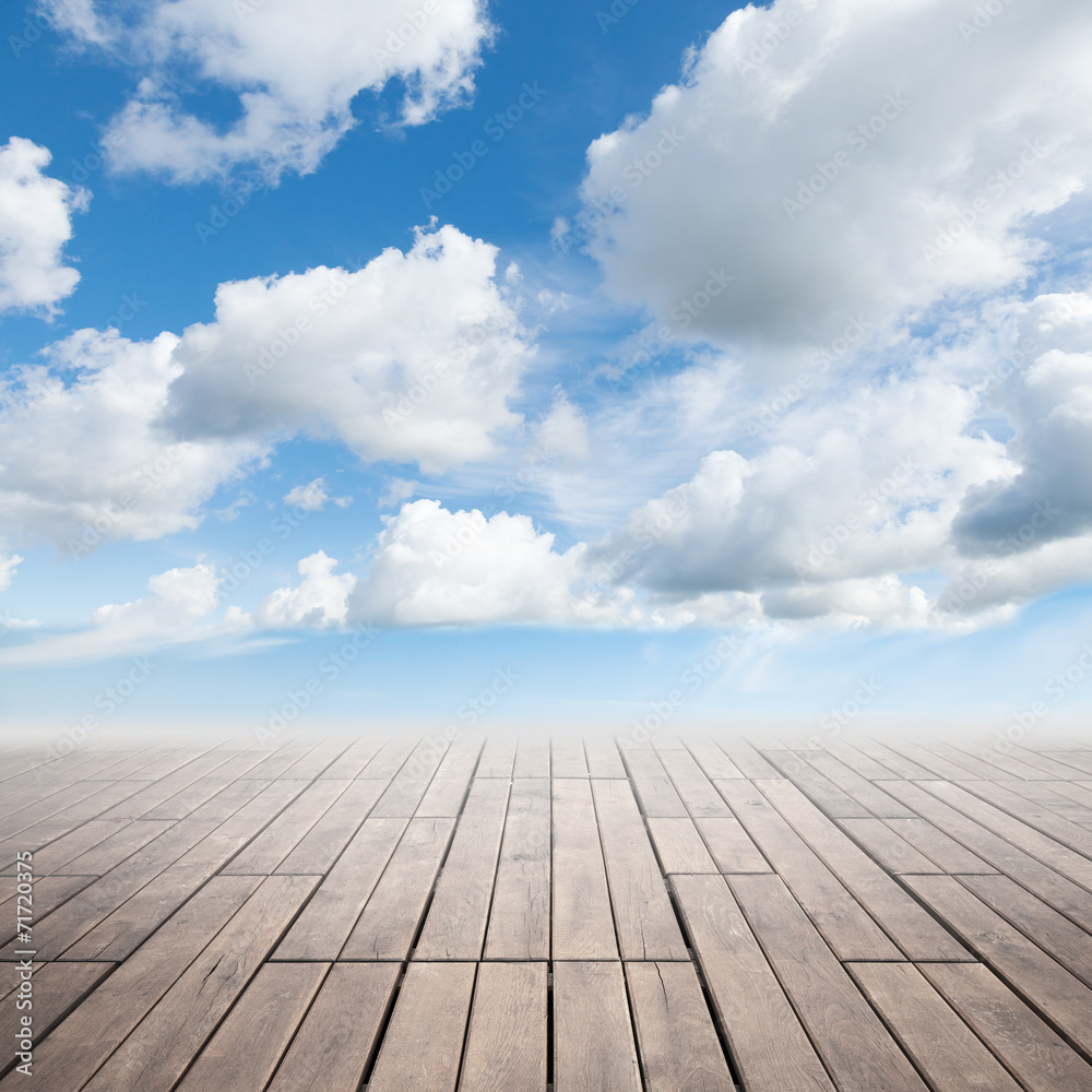 Brown wooden floor with perspective and cloudy sky