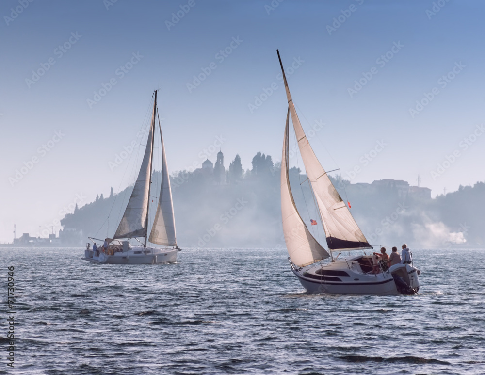 Fototapeta premium Sails in the fog. Bay of Kotor, near the Perast city, Montenegro