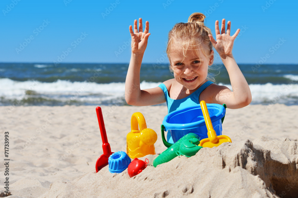 Little girl playing on the sand beach Little girl playing on the sand beach