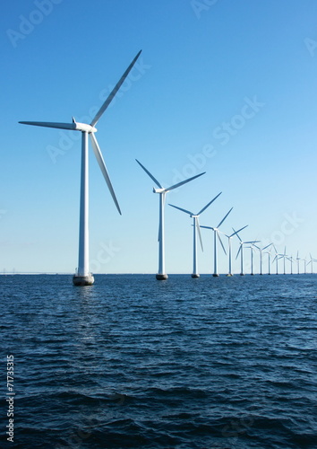 Vertical perspective of ocean windmills with horizon