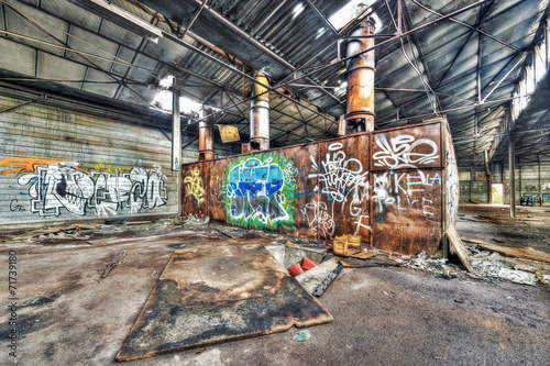 Rusted boiler in an abandoned warehouse
