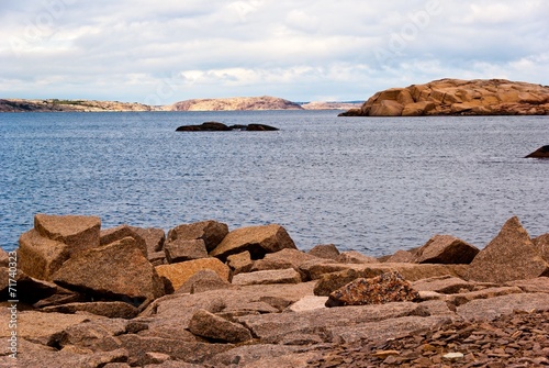 Landscape with ocean and red granite boulders.