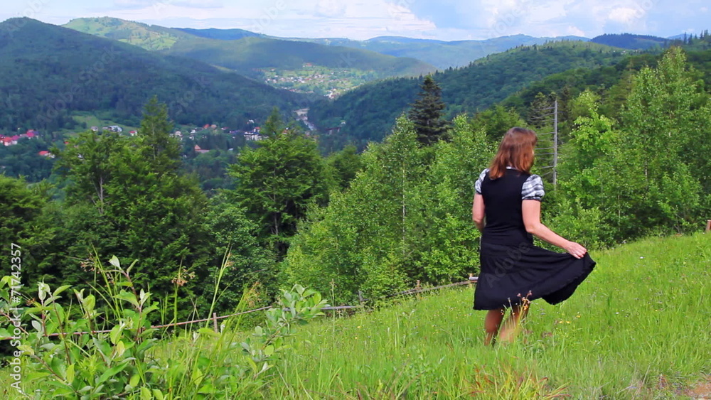 nice happy woman dances on top of hill among beautiful mountains nice happy woman dances on top of hill among beautiful mountains