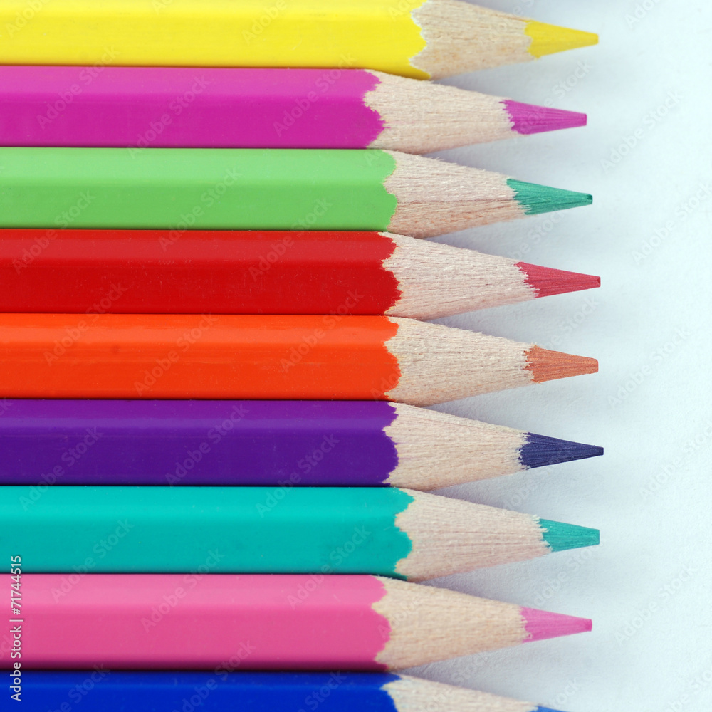 Fototapeta premium multicolored crayons in a row on white background