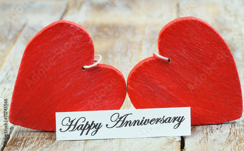 Happy Anniversary card with two red wooden hearts
