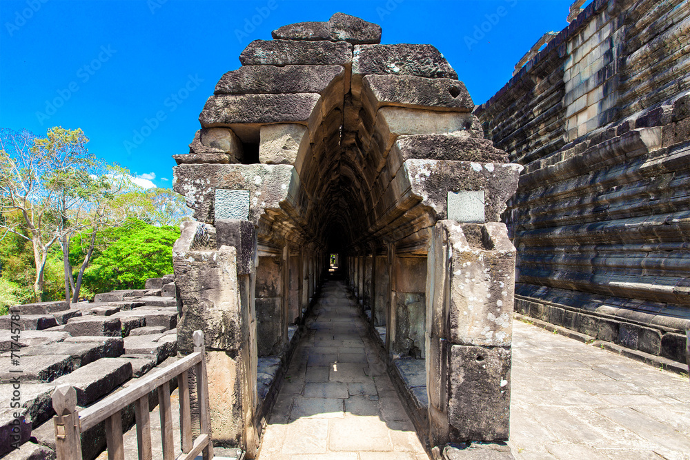 The ancient ruins of a historic Khmer temple in the temple compl